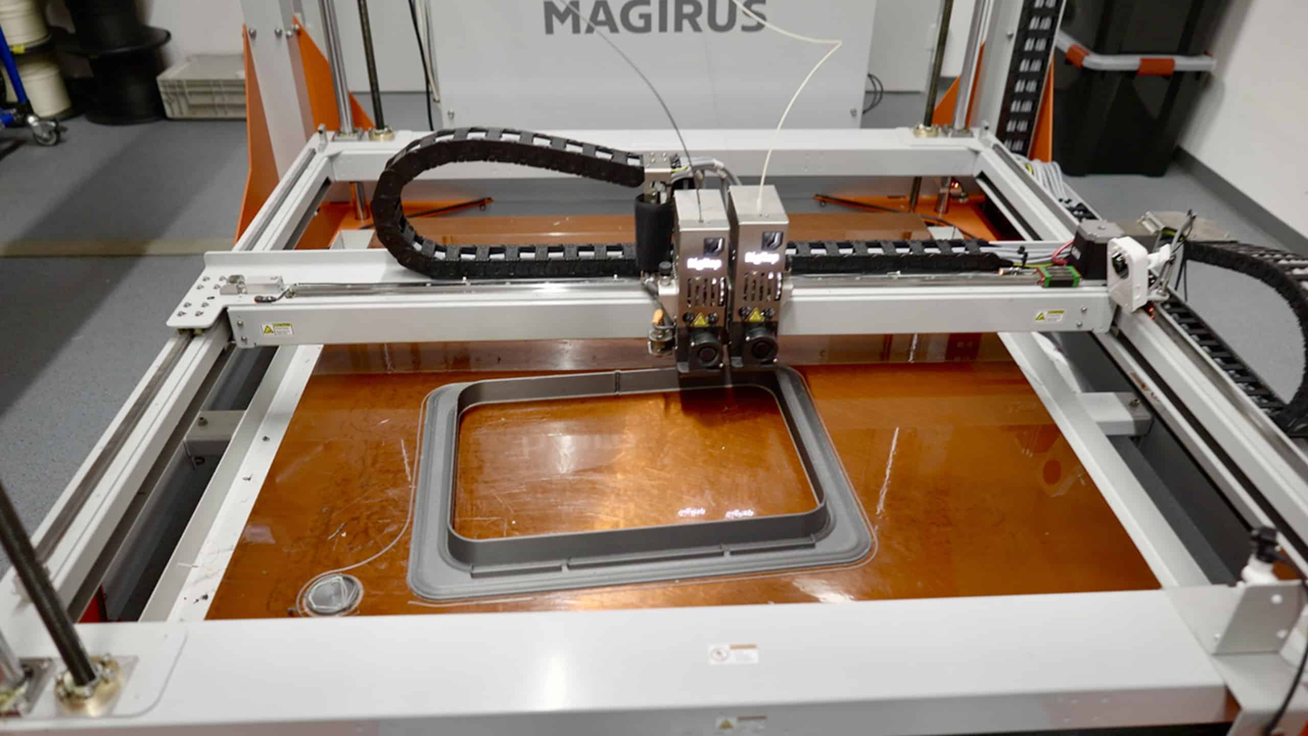 The 3D printer is used for prototyping and end-use parts. Here, a window frame that will later be an integral and load bearing part of a door is printed.