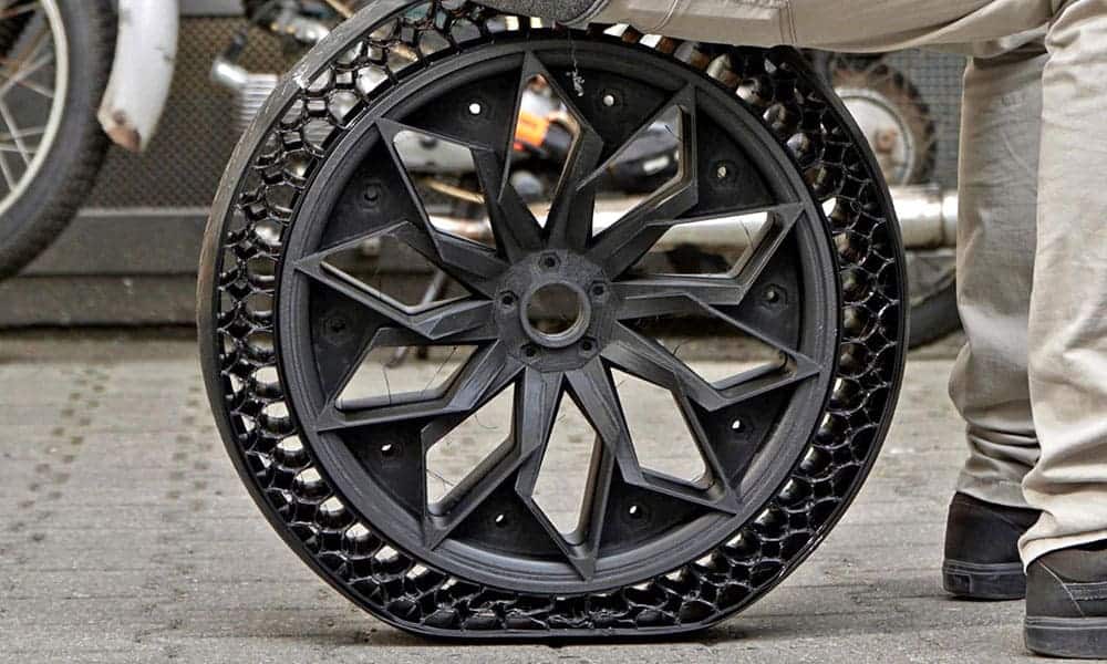 A person is sitting on a bicycle wheel