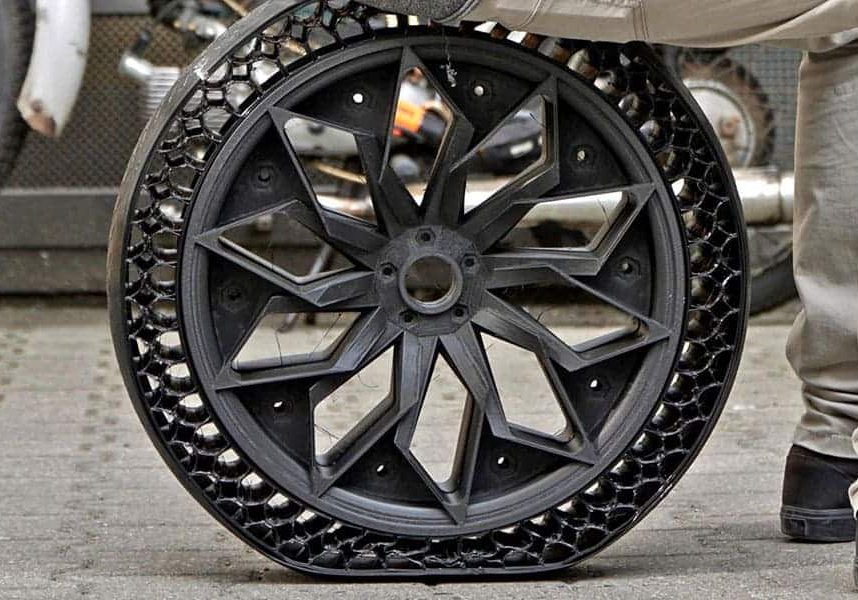 A person is sitting on a bicycle wheel
