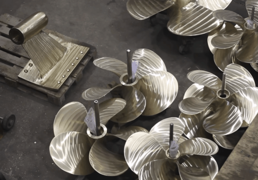 Industrial marine propellers on a workshop floor cast using molds created from 3d-printed patterns produced on a bigrep one printer